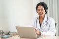 African american happy smiling young doctor in headset consulting patient over the phone. Health care call center Royalty Free Stock Photo