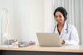 african american happy smiling young doctor in headset consulting patient over the phone. Health care call center Royalty Free Stock Photo