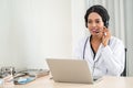 african american happy smiling young doctor in headset consulting patient over the phone. Health care call center Royalty Free Stock Photo