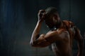 Portrait. African american male body builder posing on a black studio background. Beauty and perfection of human body Royalty Free Stock Photo