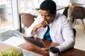 Portrait of African American male doctor in surgeon medic suit studying history disease of patient