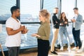 Portrait of African American male having conversation with young woman colleague, selective focus. Royalty Free Stock Photo