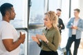 Portrait of African American male having conversation with young woman colleague, selective focus. Royalty Free Stock Photo