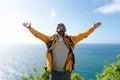 African american male hiker with backpack and arms open