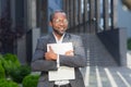 Portrait of African American male lawyer, legal advocate in suit and glasses standing posing outside near courthouse Royalty Free Stock Photo