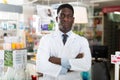 Portrait of an african american male pharmacist standing in the sales hall of a pharmacy Royalty Free Stock Photo