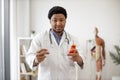 Physician holding medicine containers in consulting room Royalty Free Stock Photo