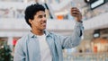 Portrait african american man guy student male indoors using mobile app phone waving hello talking video call conference Royalty Free Stock Photo