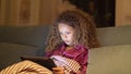 Close-up of young girl watching digital tablet