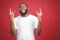 Portrait of African American man laughing isilated over red