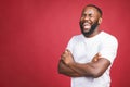 Portrait of African American man laughing isilated over red