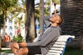 Portrait of african american man resting on bench and enjoying music Royalty Free Stock Photo