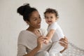 Portrait of African American mom play with toddler daughter Royalty Free Stock Photo