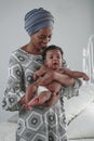 Portrait of african american mother holding her baby girl Royalty Free Stock Photo