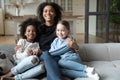 Portrait African American mother hugging two little daughters, multiracial family Royalty Free Stock Photo