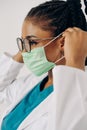 Portrait of african american nurse or doctor woman wearing medical face mask Royalty Free Stock Photo