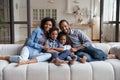 Portrait African American parents with little kids sitting on couch Royalty Free Stock Photo