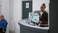 Portrait of african american receptionist working at registration desk Royalty Free Stock Photo