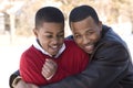 Portrait of African American teenage brothers smiling.