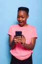 Portrait of african american teenager messaging with friend using smartphone