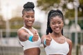 Portrait of african american tennis players with a thumbs up. Happy friends support each other before tennis practice