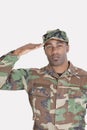 Portrait of an African American US Marine Corps soldier saluting over gray background