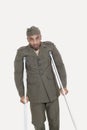 Portrait of an African American US military officer with crutches over gray background