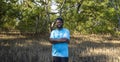 Portrait of African American volunteer man enjoy charitable social work outdoor in mangrove planting project