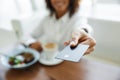 Portrait of african american woman paying in cafe with credit card Royalty Free Stock Photo