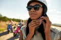 Portrait of african american woman putting on safety helmet Royalty Free Stock Photo