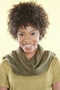 Portrait of an African American woman smiling with a stole round her neck over colored background