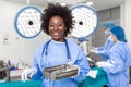 Portrait of African American woman surgeon standing in operating room, ready to work on a patient. Female medical worker in Royalty Free Stock Photo