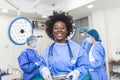 Portrait of African American woman surgeon standing in operating room, ready to work on a patient. Female medical worker in Royalty Free Stock Photo