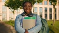 Portrait African American woman university college campus academy student teen girl high school pupil holding books with Royalty Free Stock Photo