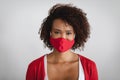 Portrait of african american woman wearing face mask against grey background Royalty Free Stock Photo