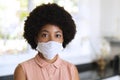 Portrait of african american woman wearing face mask and looking at camera Royalty Free Stock Photo
