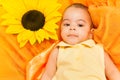 Portrait of African baby laying on sunflower cloth Royalty Free Stock Photo