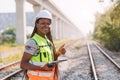 Portrait African black engineer women worker work checking service in train railway tracks construction site in transportation Royalty Free Stock Photo