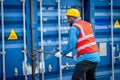 Portrait of African Engineer or foreman wears PPE checking container storage with cargo container background at sunset. Logistics Royalty Free Stock Photo