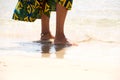 African female feet standing on the sea shore Royalty Free Stock Photo