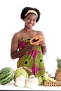 Portrait of African girl teen with curly hair wearing traditional clothes, holding papaya tropical fruit. Happy smiling African