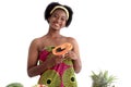 Portrait of African girl teen with curly hair wearing traditional clothes, holding papaya tropical fruit. Happy smiling African