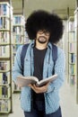 African student reading a book in the library Royalty Free Stock Photo