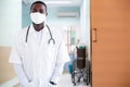 Portrait of african male doctor in face shield standing in lab coat Royalty Free Stock Photo