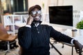 Portrait of african male executive making phone call while sitting in office. Young businessman talking on mobile phone Royalty Free Stock Photo