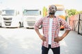 portrait African male happy Smiling confident positive near lorry. Young Man plaid shirt owner Truck Driver In Business Royalty Free Stock Photo