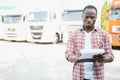 portrait African male happy Smiling confident positive near lorry. Young Man plaid shirt owner Truck Driver In Business Royalty Free Stock Photo