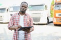 portrait African male happy Smiling confident positive near lorry. Young Man plaid shirt owner Truck Driver In Business Royalty Free Stock Photo