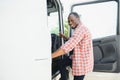 portrait African male happy Smiling confident positive near lorry. Young Man plaid shirt owner Truck Driver In Business Royalty Free Stock Photo