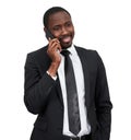 Portrait of african man smiling while talking on the phone with grey wall isolated on white background Royalty Free Stock Photo